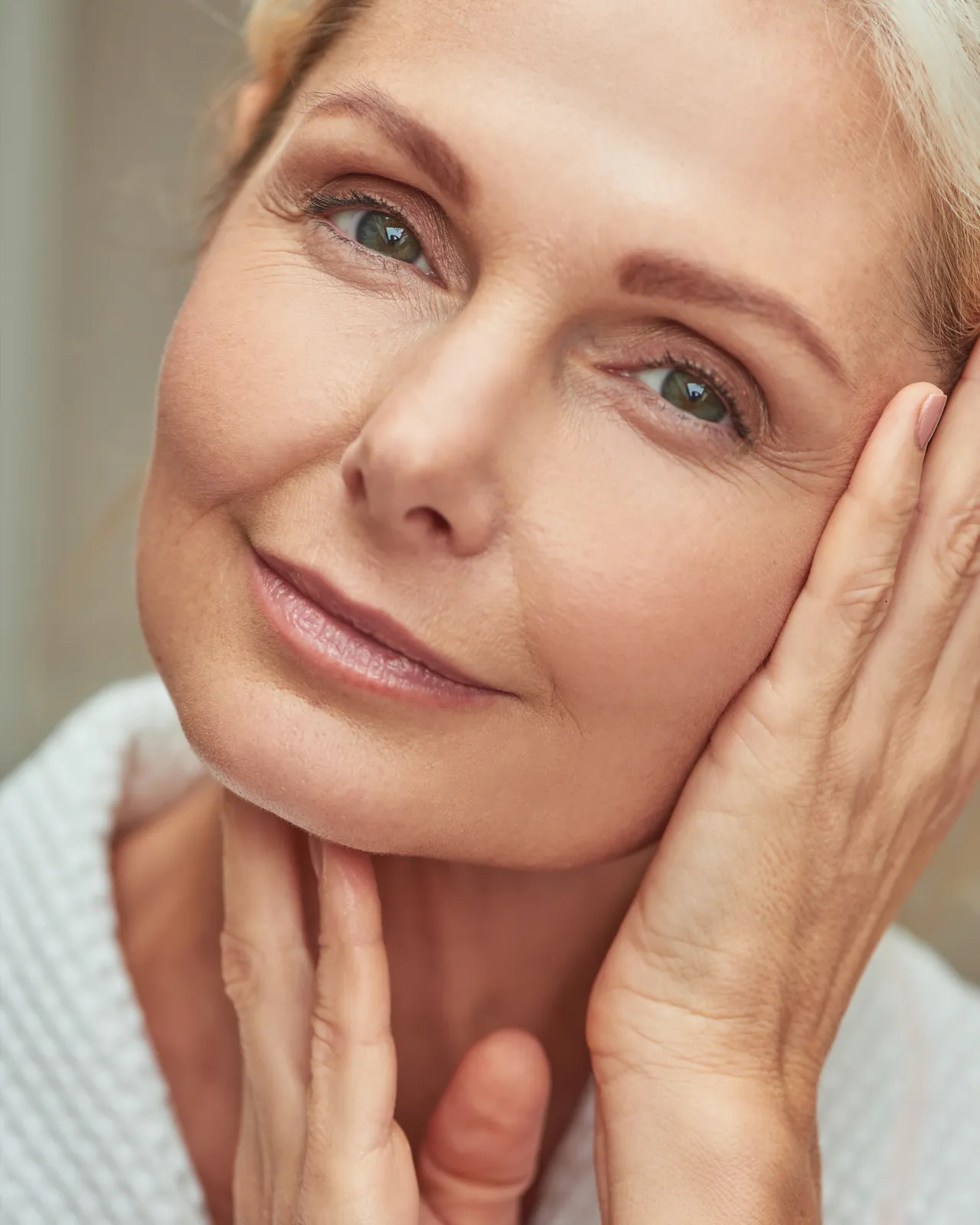 Middle-aged woman touching her face