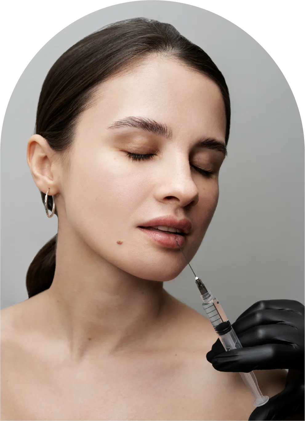Woman receiving an injection in the cheek area