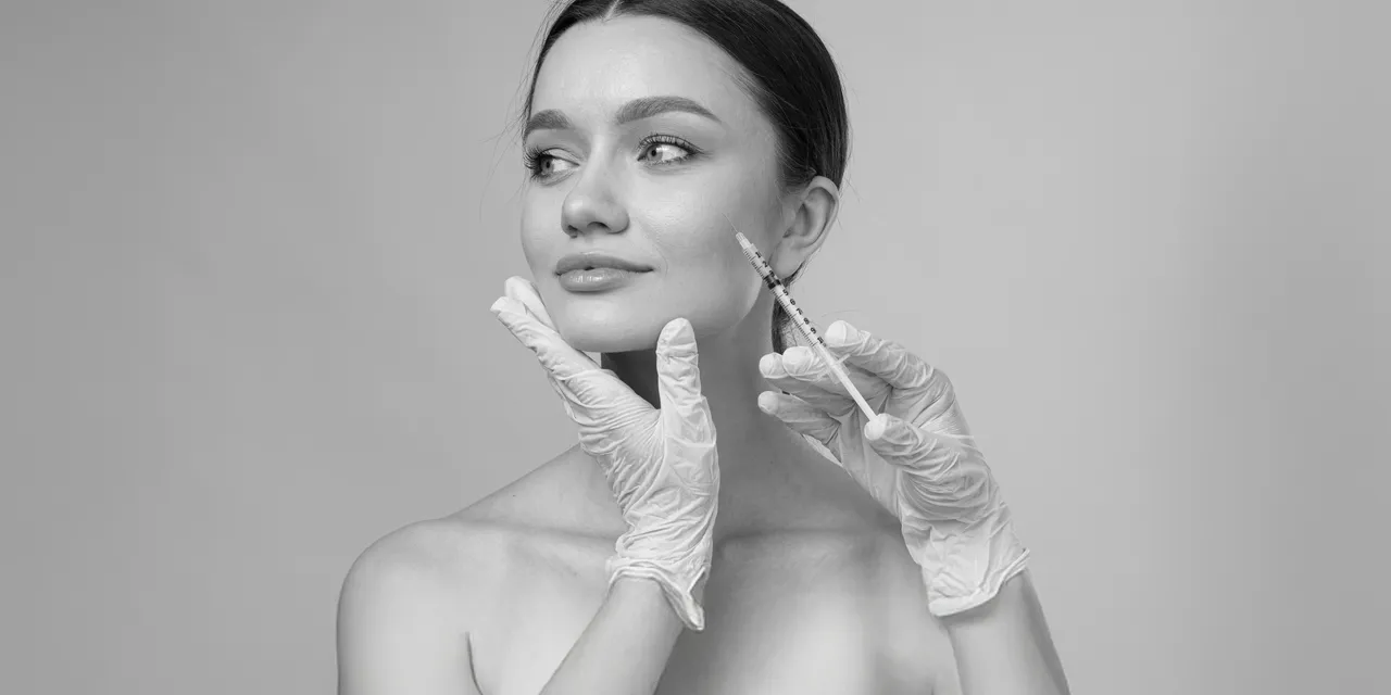 Woman during a facial aesthetic treatment (black and white)